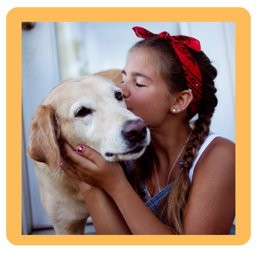 A girl kissing a dog